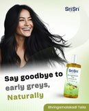 Advertisement for Sri Sri Tattva hair care product with a woman and bottle on a light green background