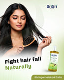 Woman with long hair holding a comb with Sri Sri Tattva product on a light green background