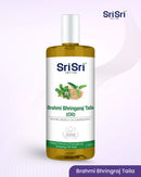 Sri Sri Tattva Brahmi Bhringraj Taila oil bottle on a light purple background