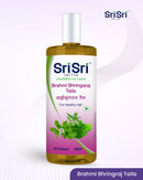 Sri Sri Tattva Brahmi Bhringraj Taila bottle on a light purple background