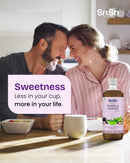 Couple sitting together with a bottle of Sri Sri products in a kitchen setting.