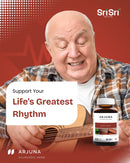 Elderly man joyfully playing an acoustic guitar, captioned "Support Your Life's Greatest Rhythm," promoting the Arjuna Ayurvedic Herb Heart Tonic