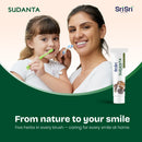 Woman and child brushing teeth with Sudanta toothpaste, featuring Sri Sri Tattva Canada