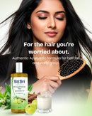 Woman brushing her hair beside Bhringamalakadi Taila; authentic Ayurvedic formula for hair fall and early greys